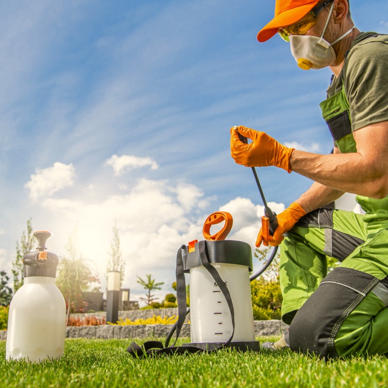 Caucasian Worker in His 40s Preparing Pest Control Spraying Equipment northport al